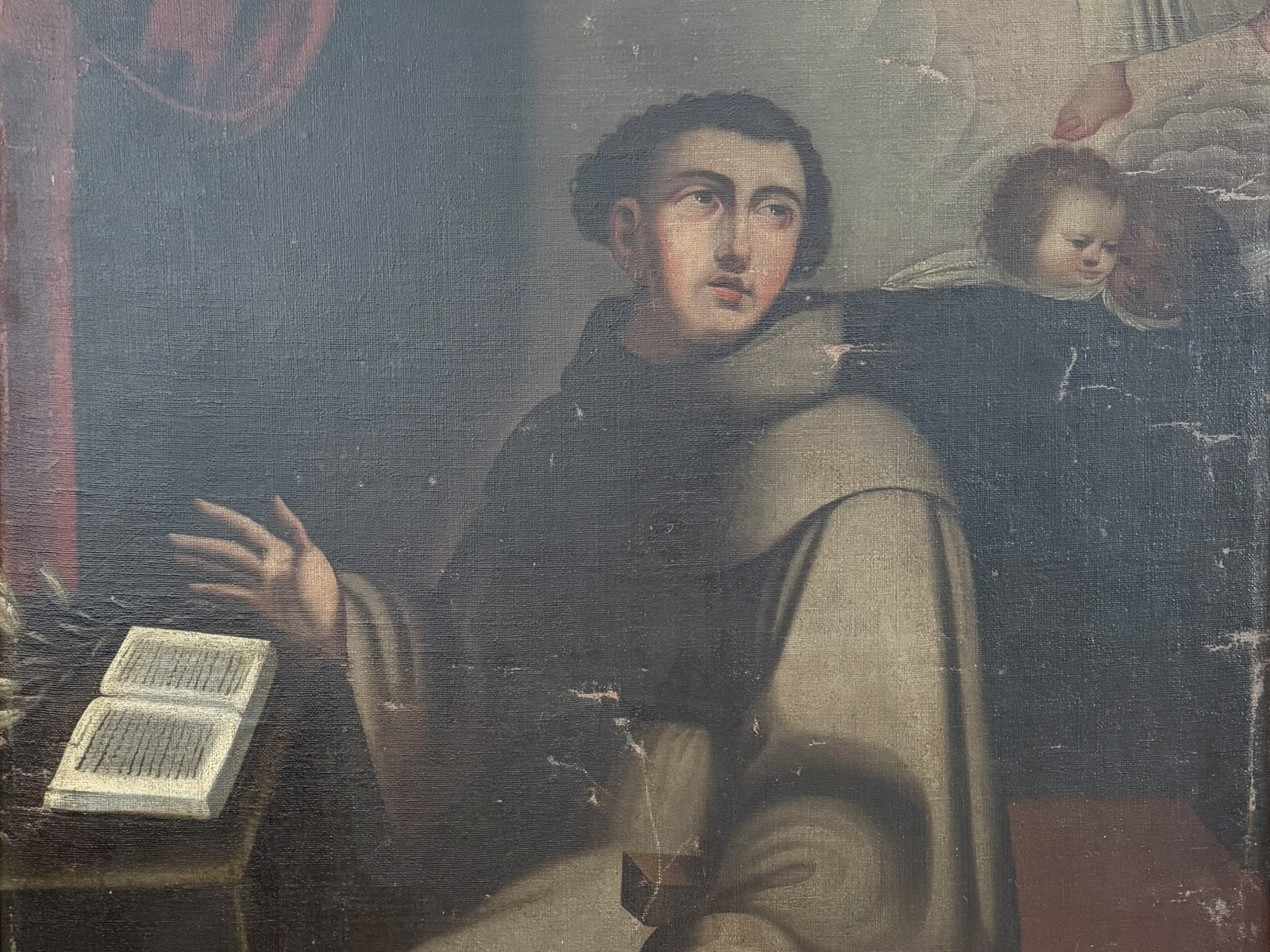 San Antonio de Padua de rodillas en su visión del Niño Jesús, con un libro abierto